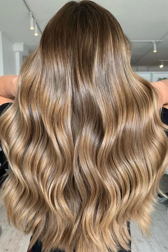 balayage on wavy brunette hair at Maison Privee