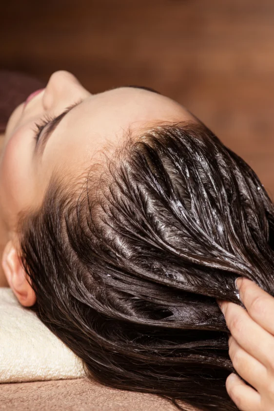 Person receiving a dual-action scalp treatment aimed at balancing both dry and oily