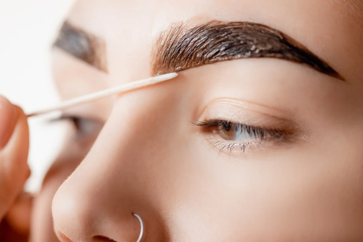 Eyebrow tinting application showcasing hybrid tints for fuller, defined brows