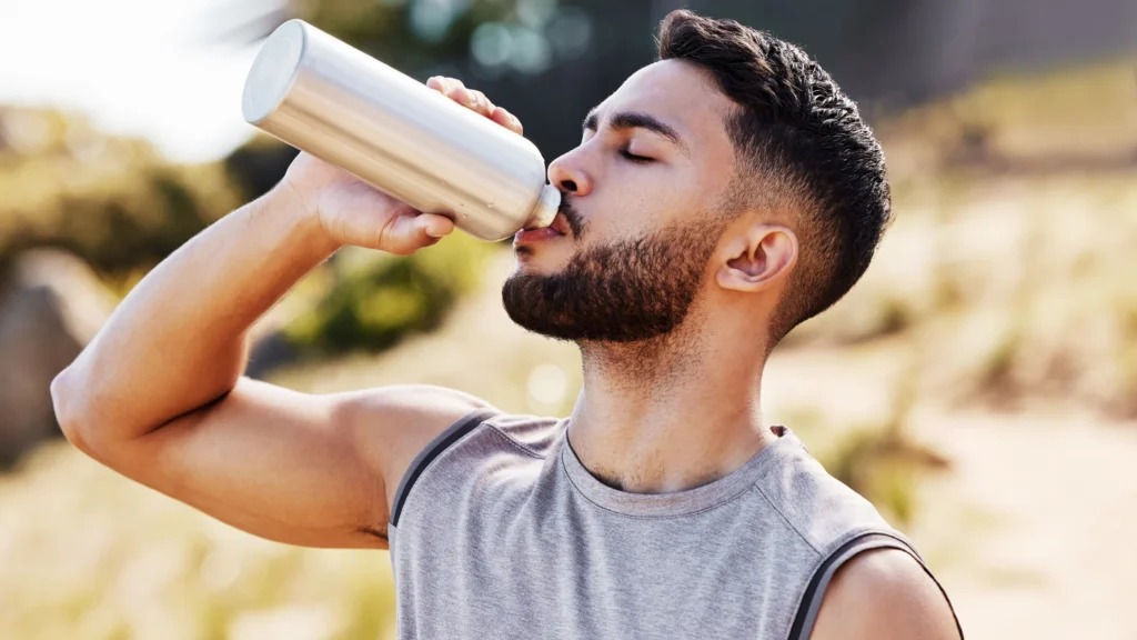 a man drinking from a bottle