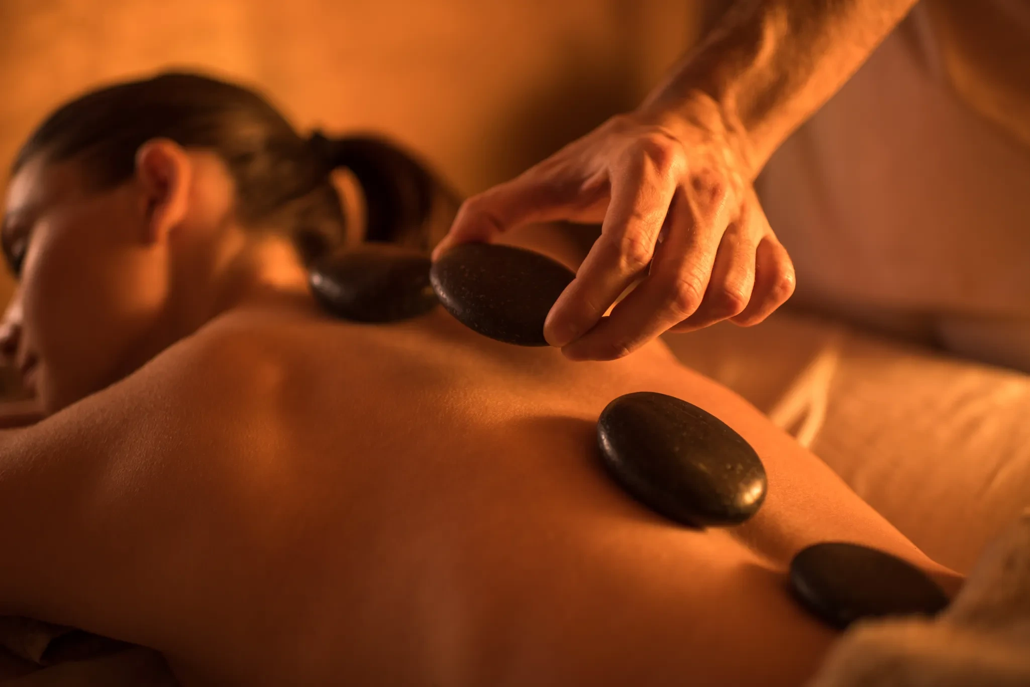 Hot stone massage at home Dubai — heated basalt stone therapy