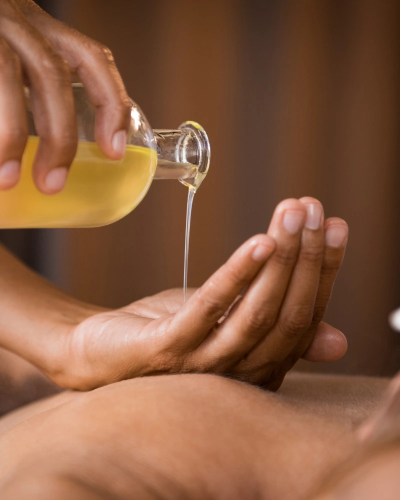 Aromatherapy massage with essential oils being applied during a home session in Dubai