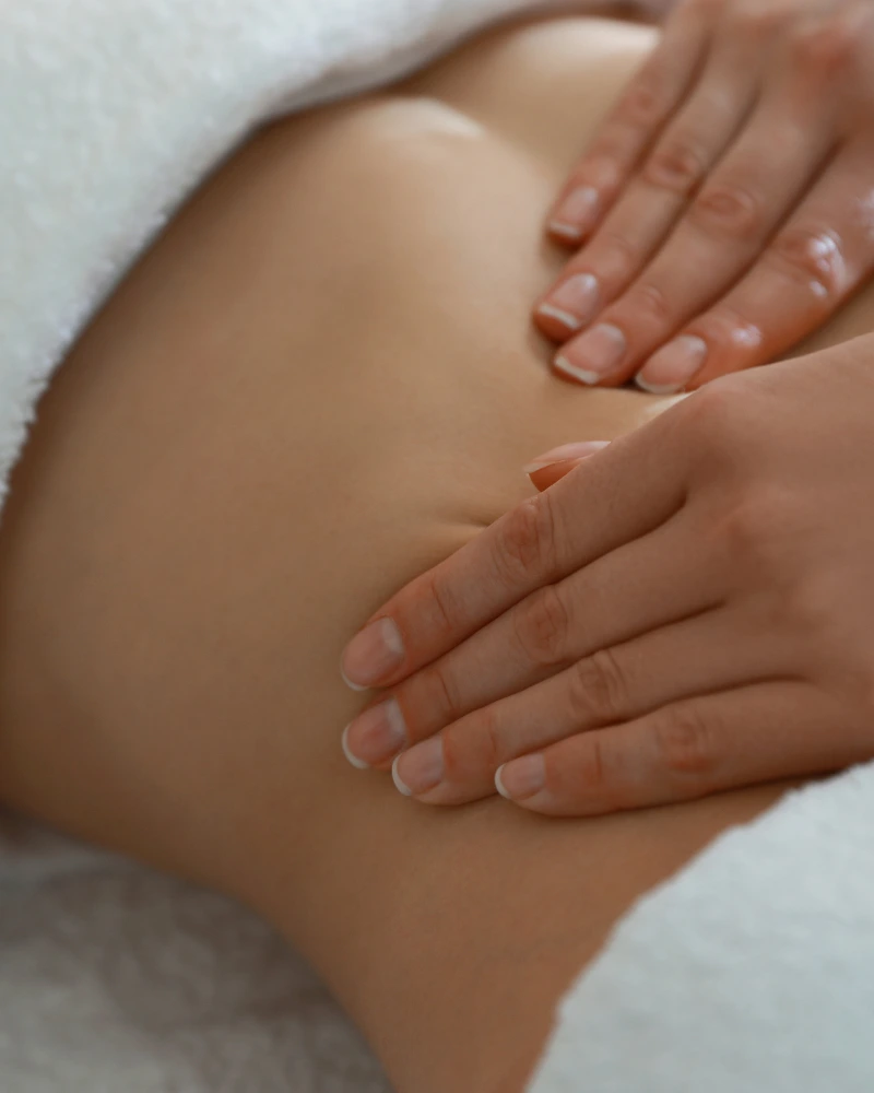 Certified therapist performing post natal recovery massage at home in Dubai